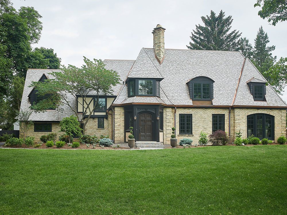 Second view from the frontyard of the roofing work Buist provided for a Tudor style residential home in East Grand Rapids, MI