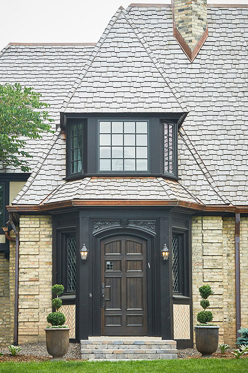 A view of the roofing and siding work buist completed for a Tudor style residential home in East Grand Rapids