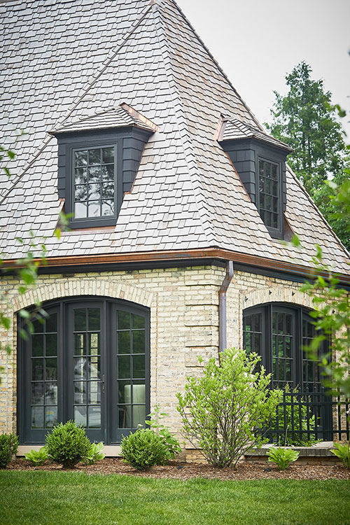 A view from the frontyard of the roofing work Buist provided for a Tudor style residential home in East Grand Rapids, MI