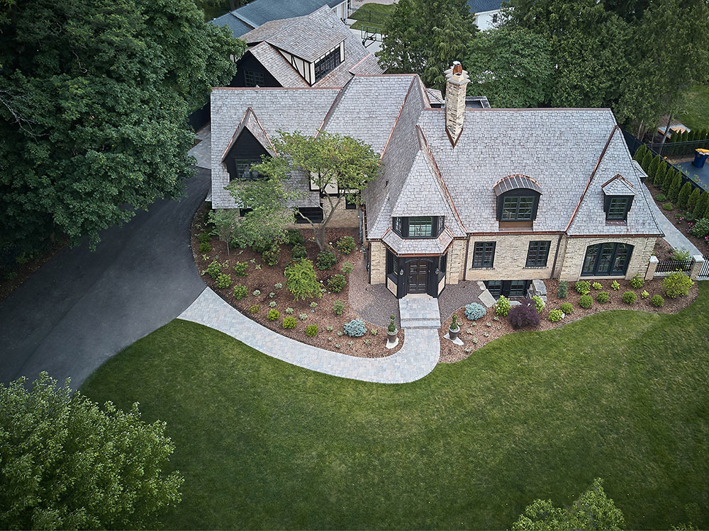 Aerial view of the full roofing work Buist provided for a Tudor style residential home in East Grand Rapids, MI