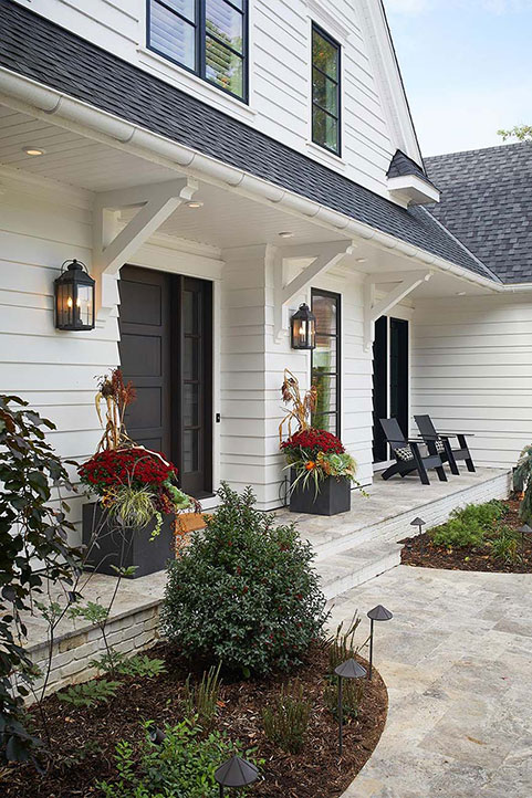 A view of the front entrance of a siding and roofing project Buist completed for a residential home on the Thornapple River in Ada, Michigan.