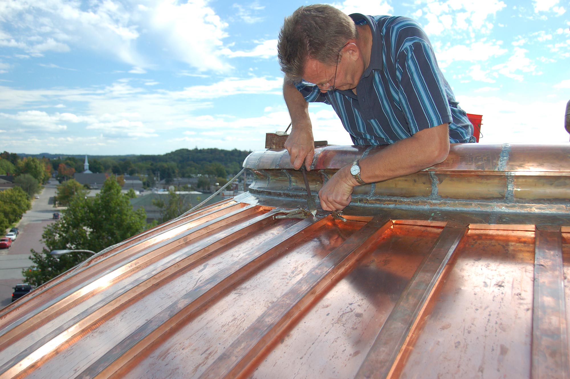 One of Buist Sheet Metal's employees working on the copper dome.