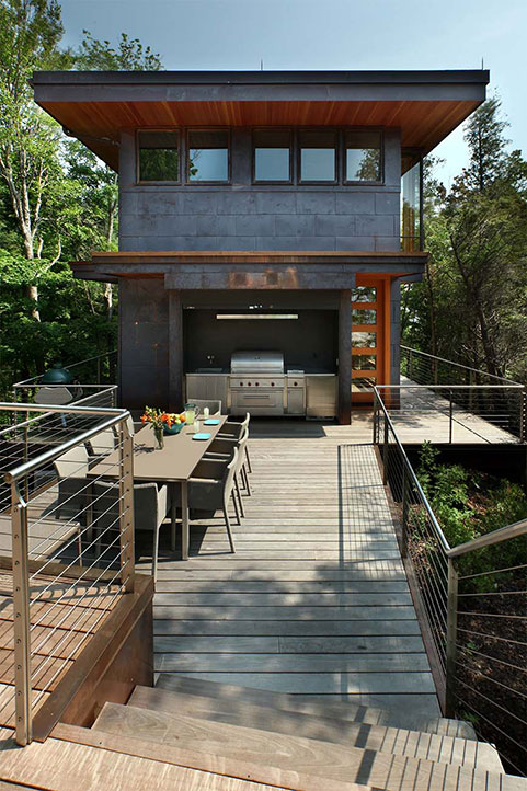 view of the Dunes residential sheet metal construction project as seen from the center of the elevated deck. You can see the outdoor dining table and modern grilling kitchenette.